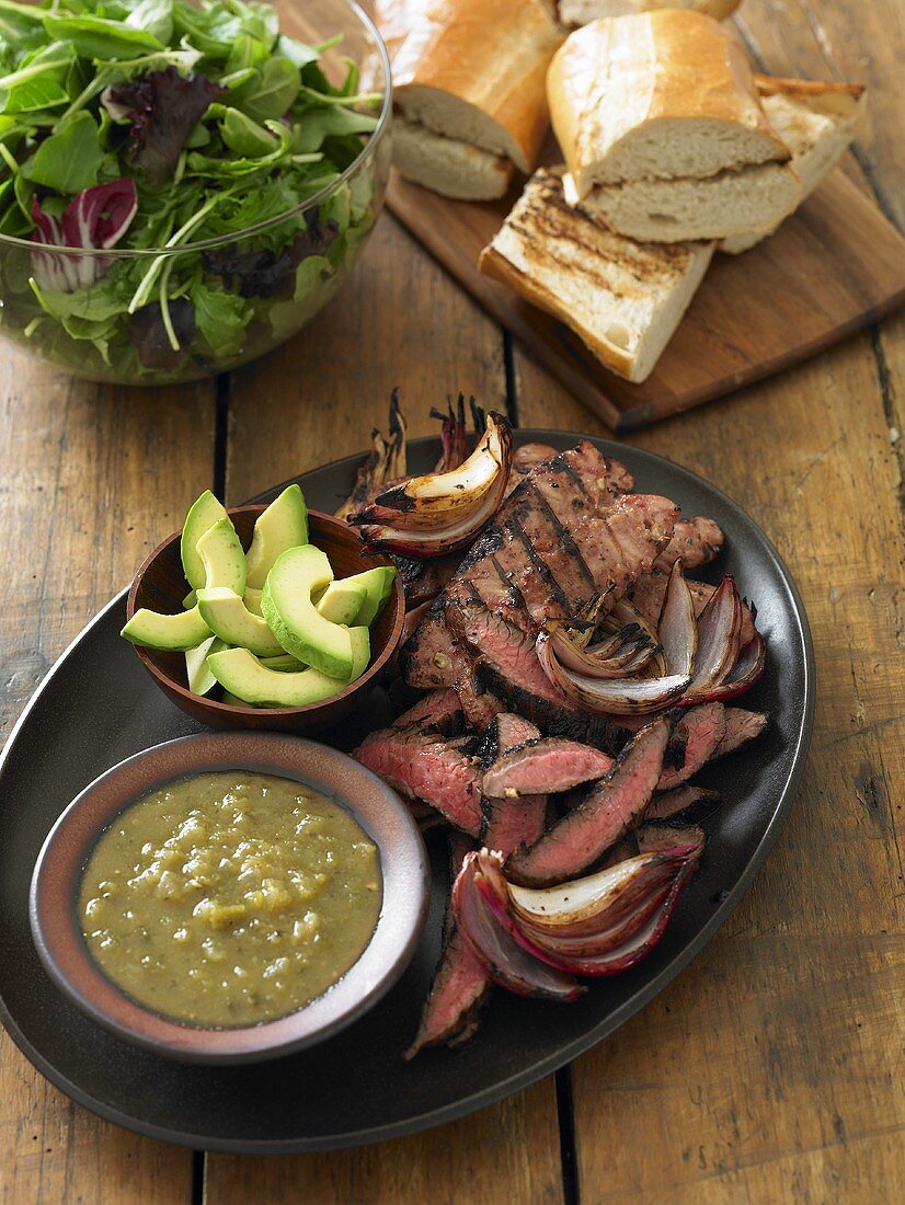 Sliced Grilled Steak and Avocado on a Platter for Steak Sandwiches