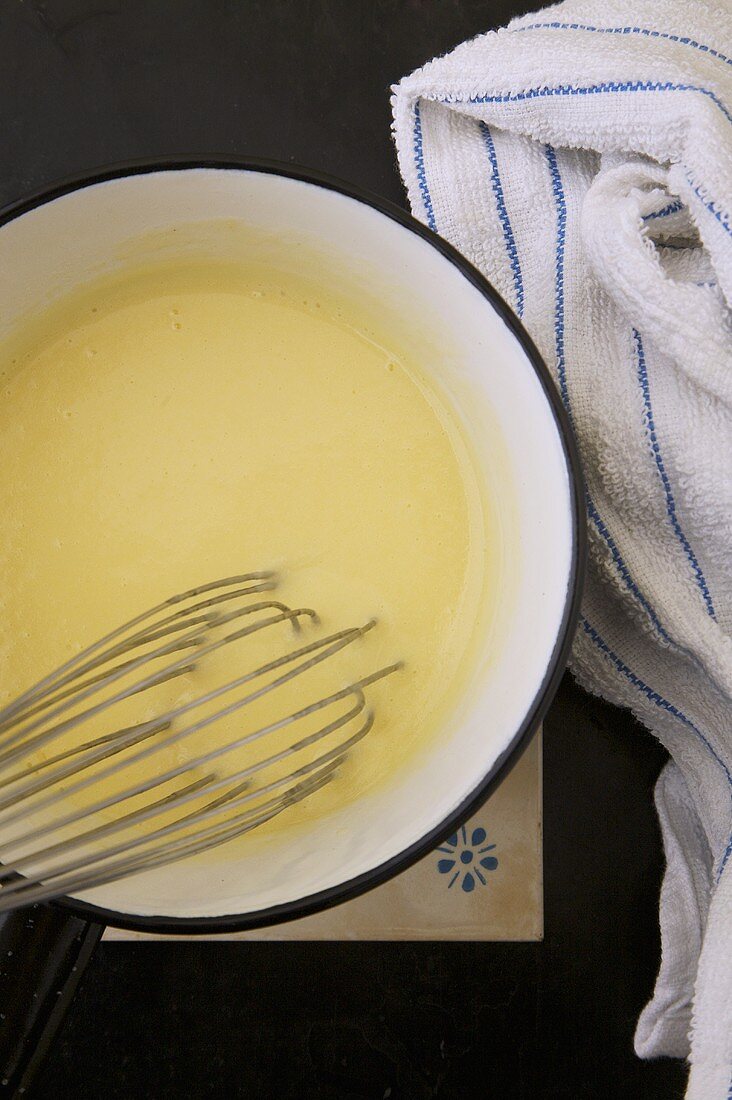 White Butter Sauce in Bowl with Whisk 