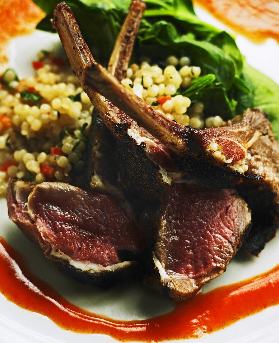 Seared Lamb Chop Lollipops on Moroccan Couscous with Red Chili Coulee 