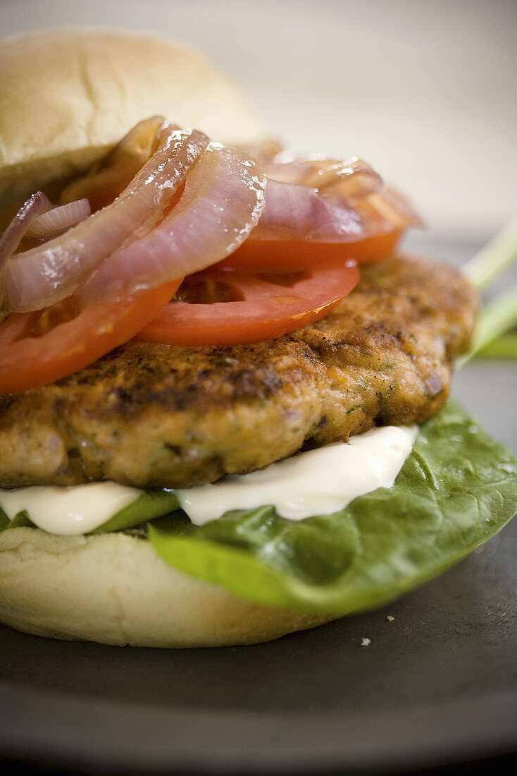 Trout Burger with Tomato and Onion on a Bun