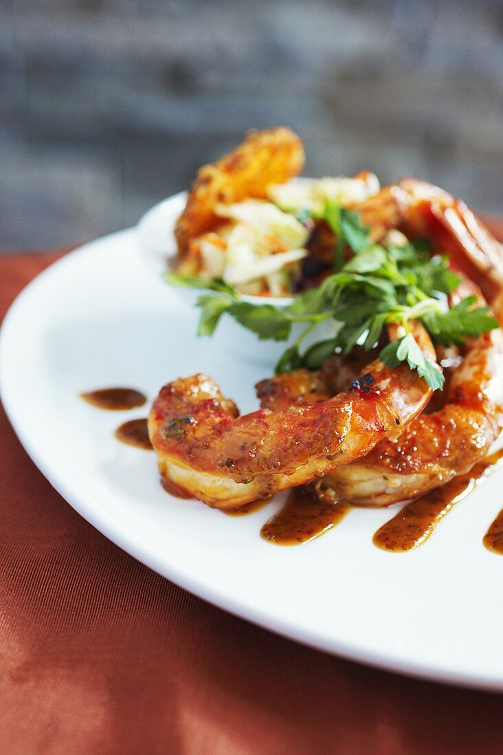 Grilled Shrimp on Plate with Sauce, Herbs, and Side of Slaw