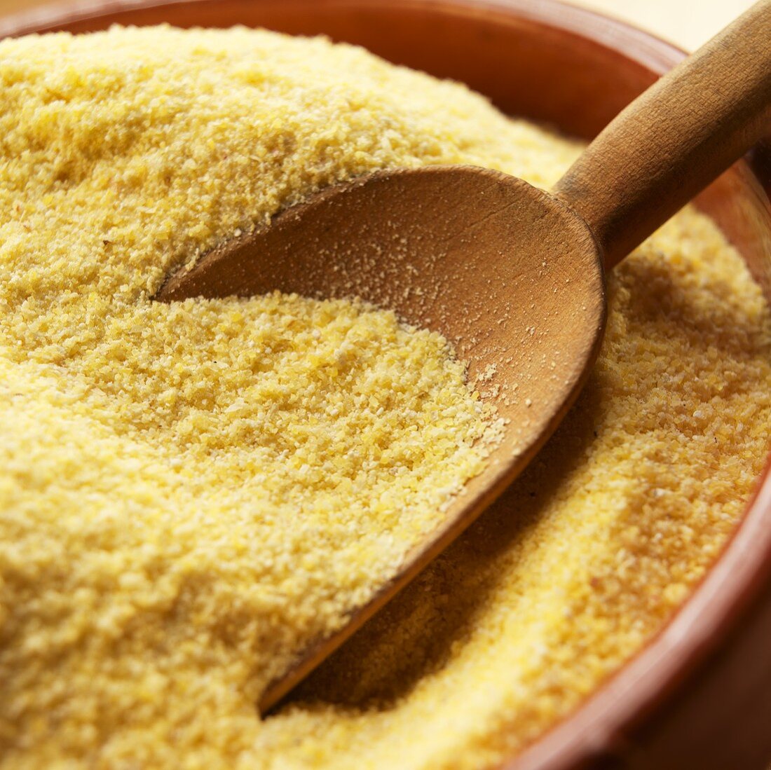 Bowl of Cornmeal with Wooden Scoop