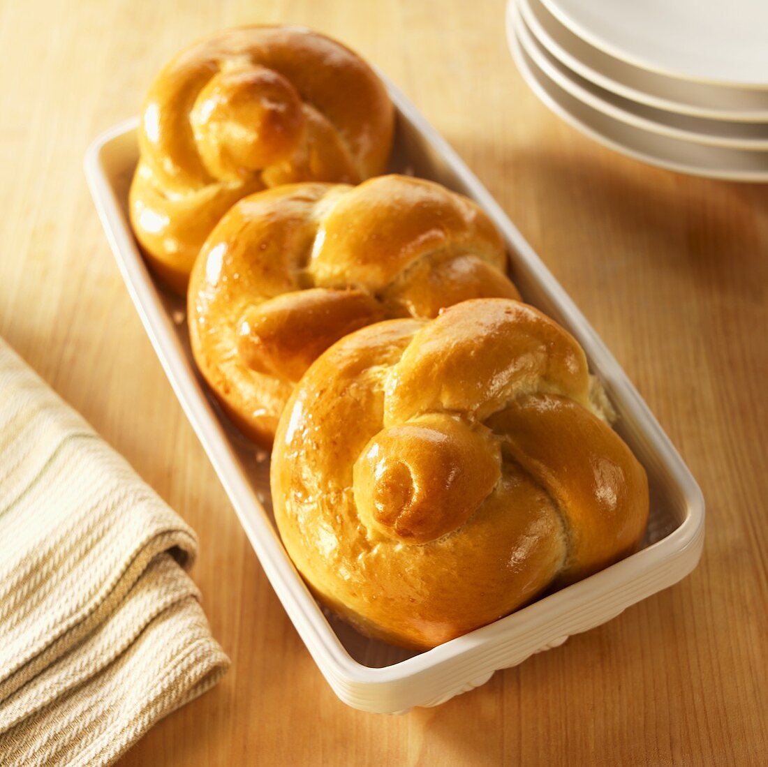 Three Challah Rolls in Ceramic Basket