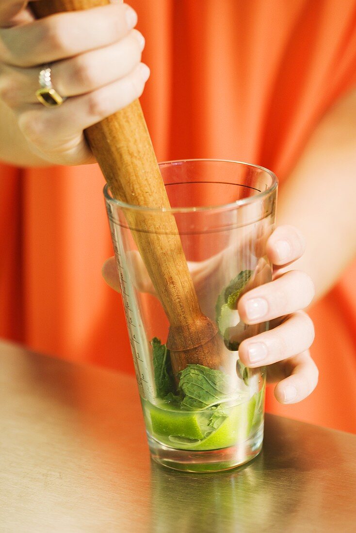 Woman Mudding Herbs for Cocktail