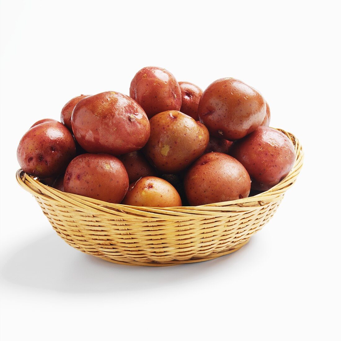 Red Potatoes in a Basket on White Background