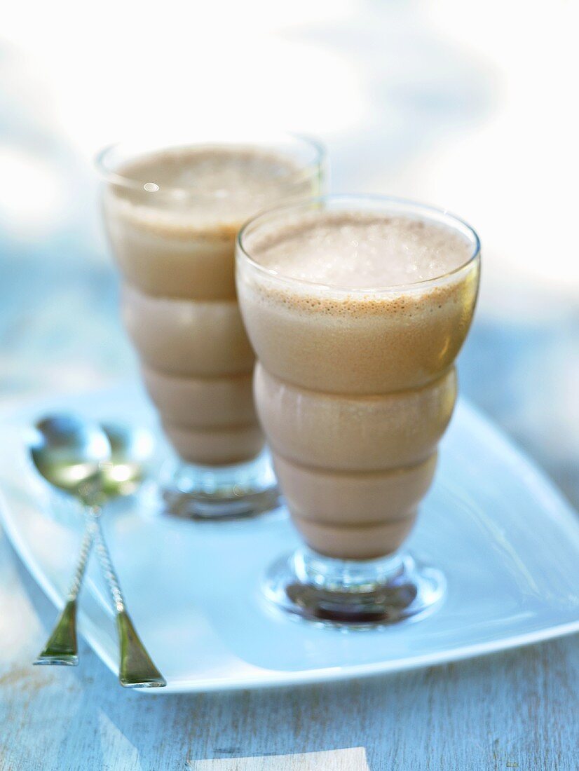 Two Chocolate Milkshakes with Spoons