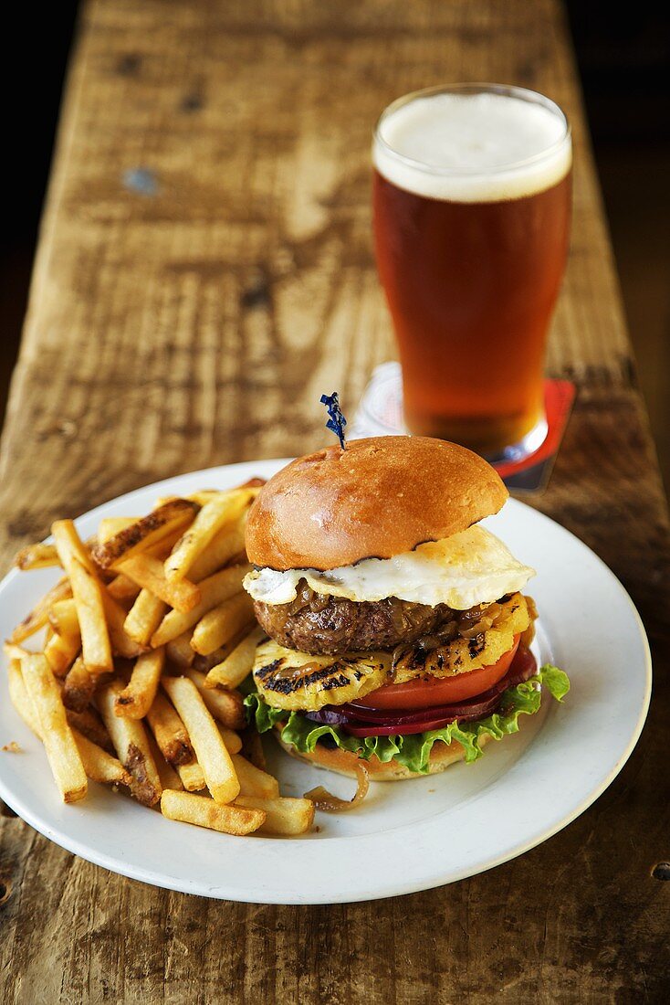 Australian Burger with Fried Egg and Pineapple; Fries and Beer