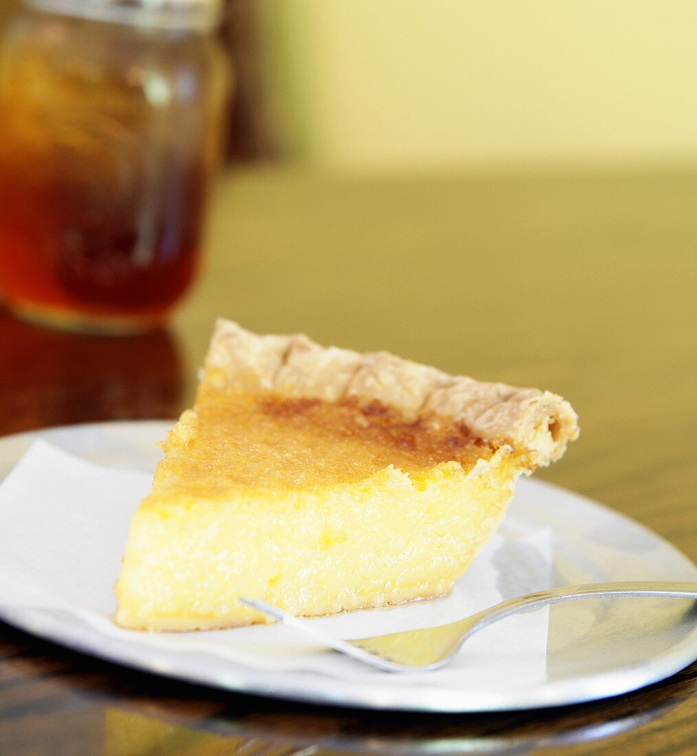 Slice of Lemon Chess Pie on a White Plate with Fork