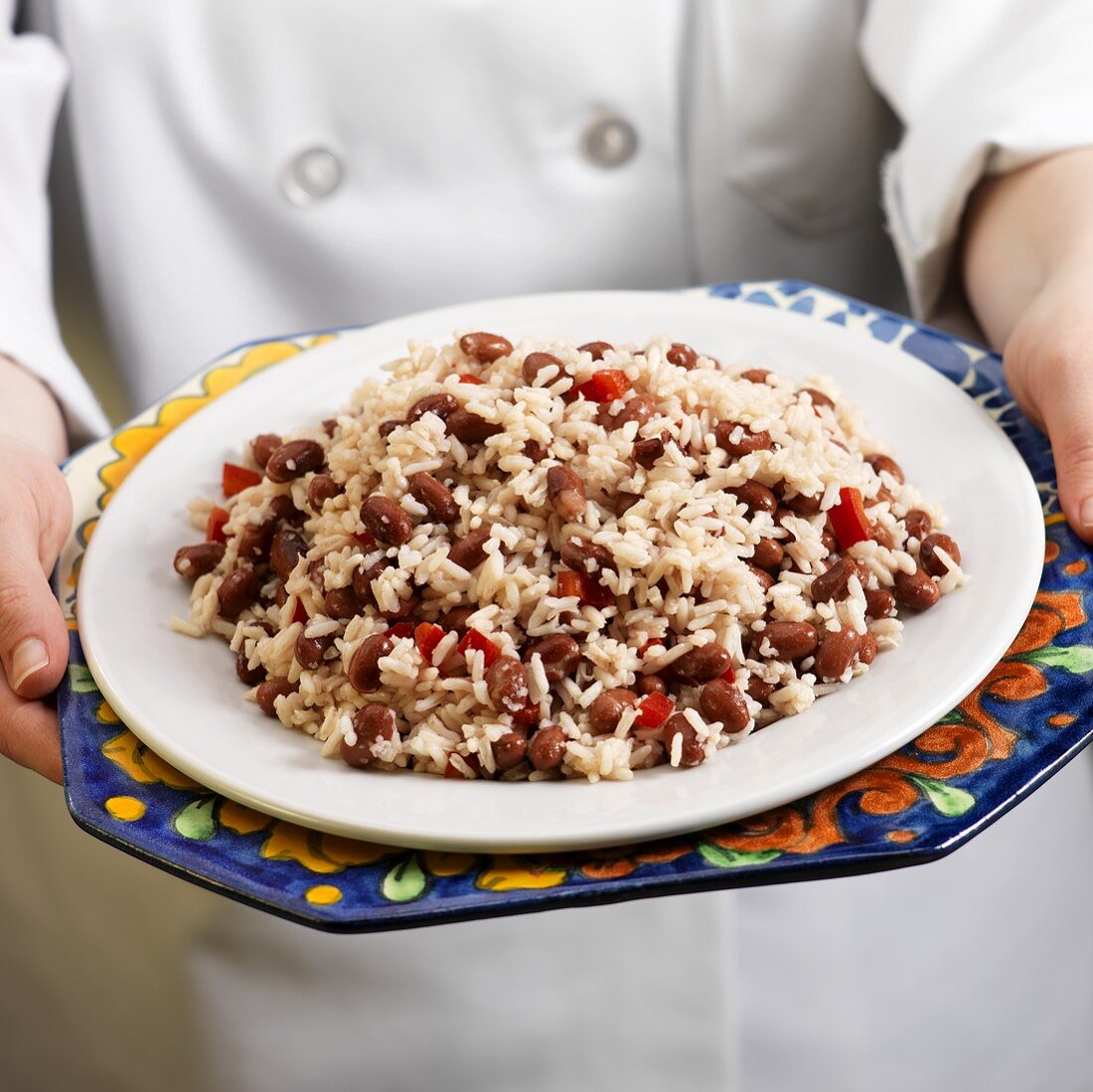 Hands Holding a Plate of Red Beans and Rice