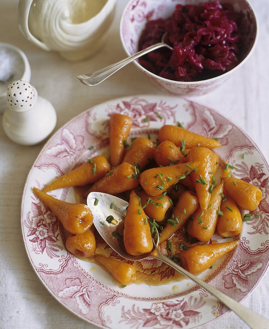 Plate of Roast Baby Carrots with Serving Spoon