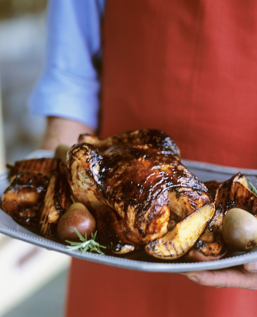 Carrying a Platter with Whole Honey Grilled Chicken with Pears