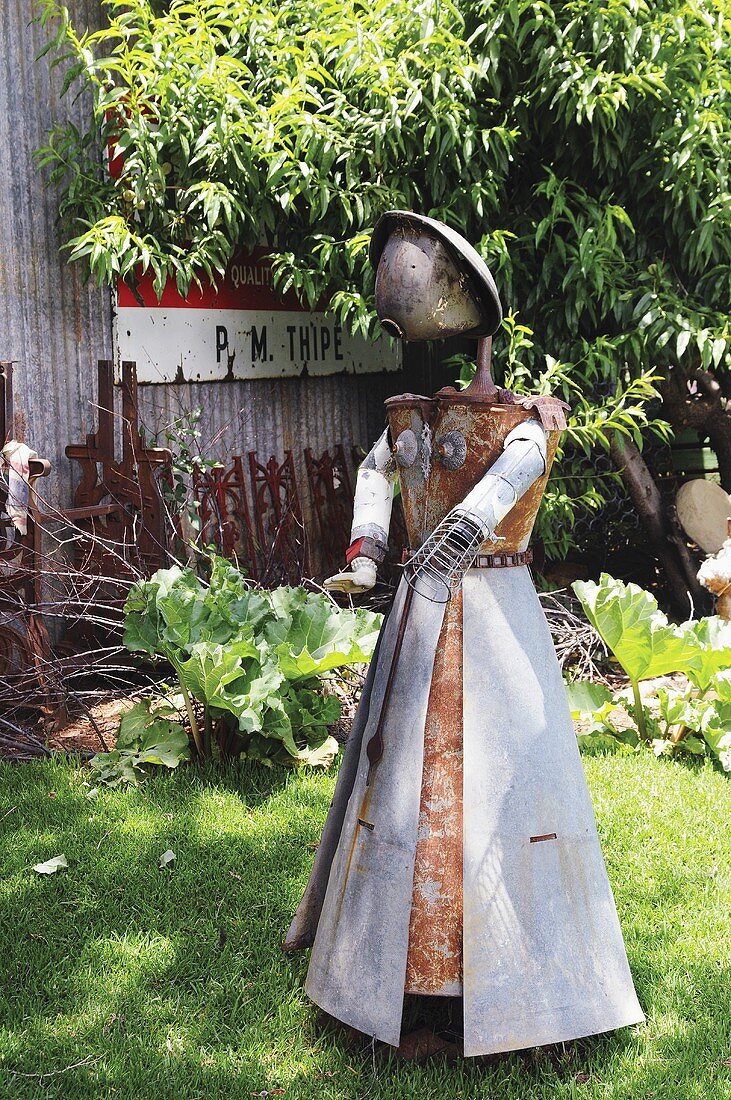 A figure made of scrap metal in a garden