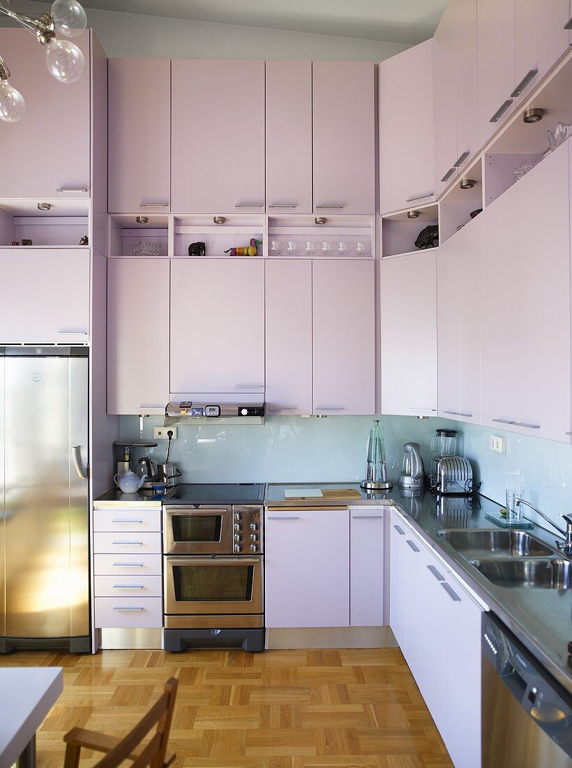 A modern kitchen with high cupboards and fitted appliances