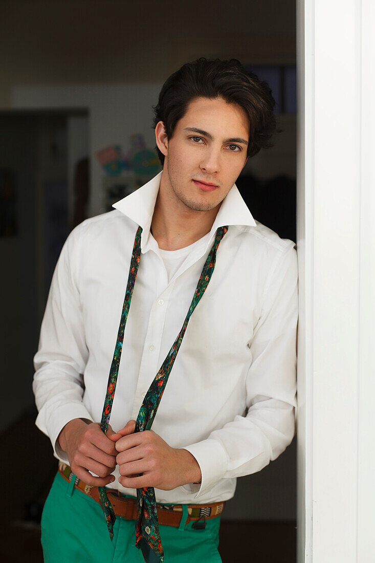 Young man getting dressed, Shirt and tie