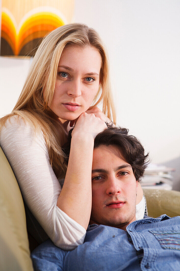 Young couple relaxing on the sofa, Embrassing