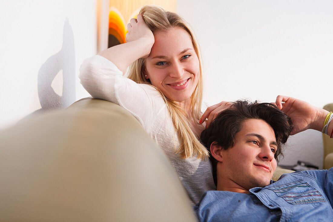 Young couple relaxing on the sofa, Embrassing