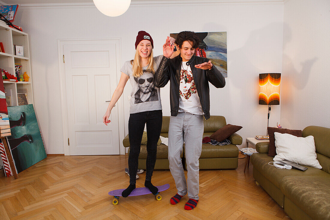 Young couple fooling around in the lounge