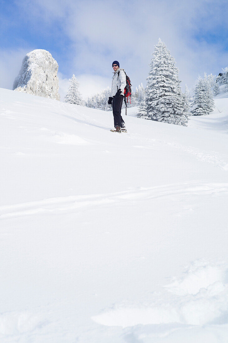 Snowboarder off piste in a winter landscape, Kampenwand, Alps, Bavaria, Germany