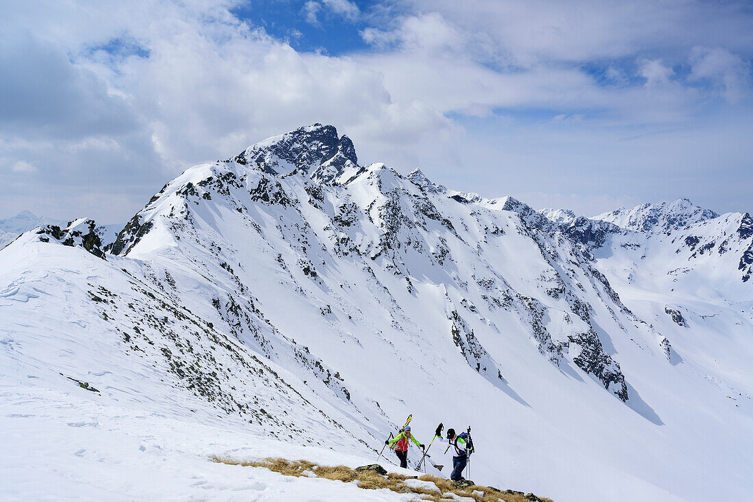 Two persons back-country skiing ascending towards Piz Sursass, Piz Nuna in the background, Piz Sursass, Sesvenna Alps, Engadin, Grisons, Switzerland