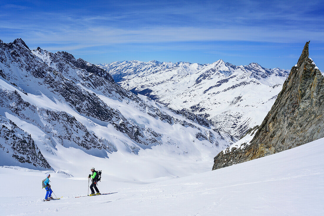 Two persons back-country skiing standing at glacier of Dreiherrnspitze, Dreiherrnspitze, valley of Ahrntal, Hohe Tauern range, South Tyrol, Italy