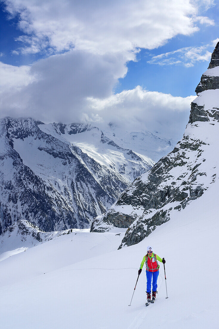 Woman back-country skiing ascending towards Grundschartner, Grundschartner, Zillergrund, Zillertal Alps, Tyrol, Austria
