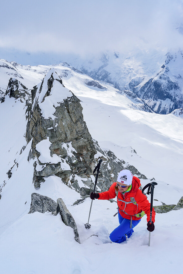 Woman back-country skiing ascending on ridge towards Grundschartner, Grundschartner, Zillergrund, Zillertal Alps, Tyrol, Austria