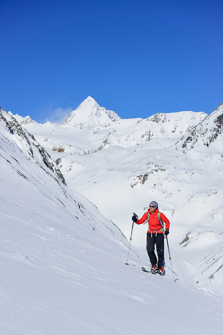 Woman back-country skiing ascending towards Monte Cevedale, Koenigsspitze in background, Monte Cevedale, valley of Martell, Ortler range, South Tyrol, Italy