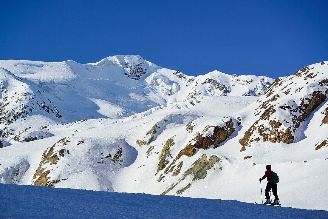 Woman back-country skiing ascending towards Punta San Matteo, Punta San Matteo, Val dei Forni, Ortler range, Lombardy, Italy