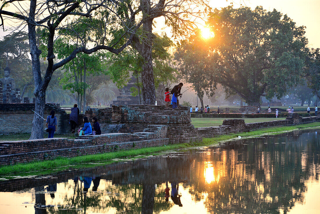 Sunrise and reflection of trees in Old-Sukhothai, Thailand