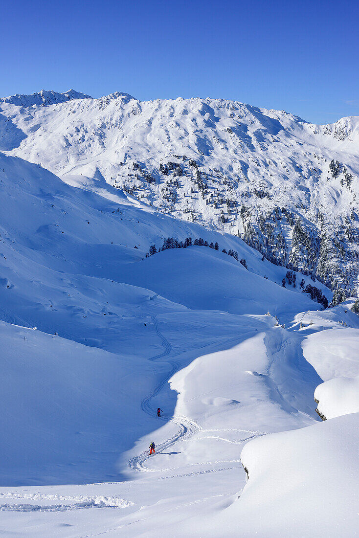Two persons back-country skiing ascending towards Pallspitze, Pallspitze, Langer Grund, Kitzbuehel range, Tyrol, Austria