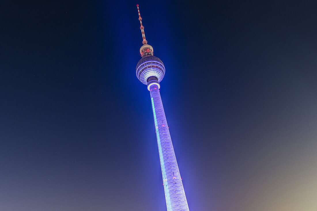 Colourfully illuminated TV tower Alex at night, Berlin Alexanderplatz, Berlin, Germany