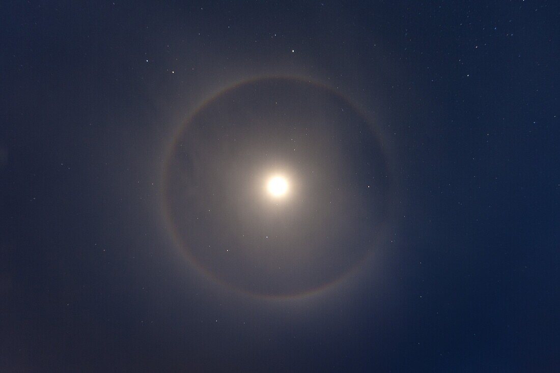 Ice crystals reflecting light in ring around moon, Ostional Beach, Costa Rica