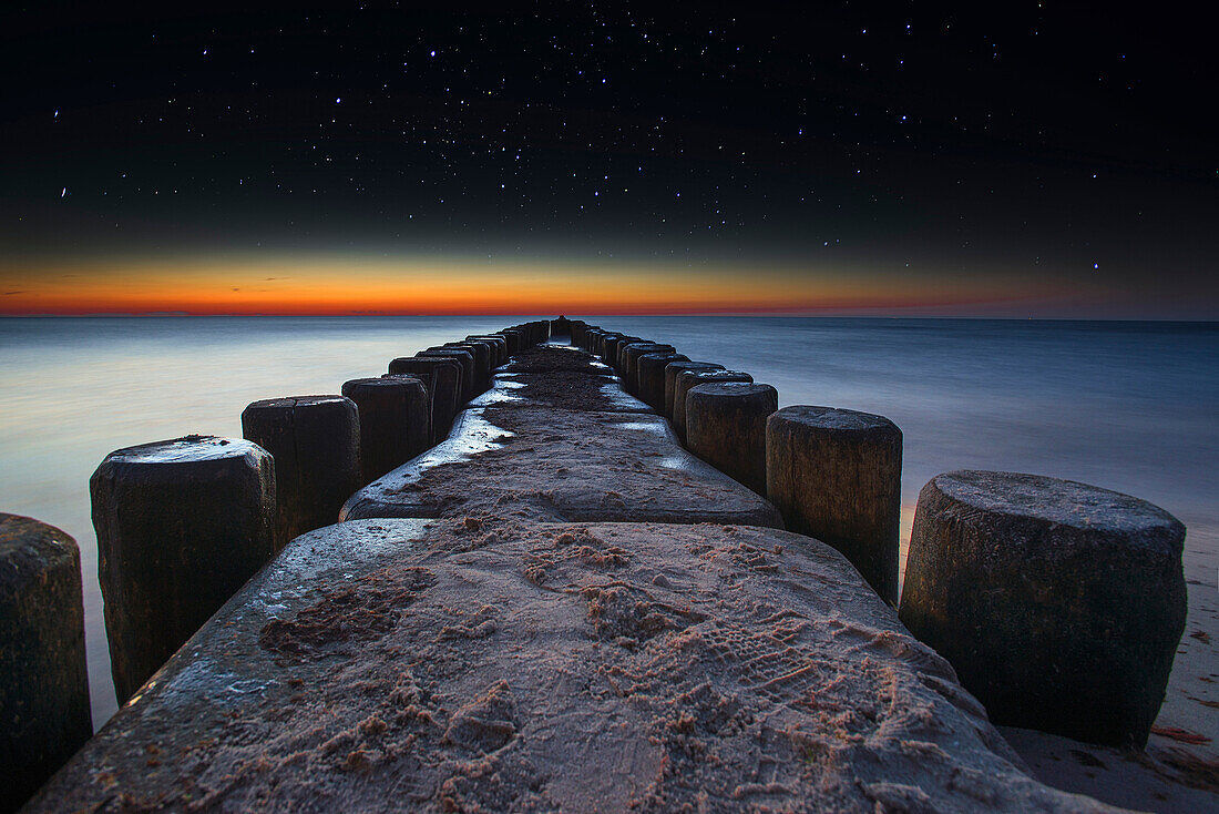 Groynes on a Baltic sea beach in the evening with starry sky, Dierhagen, Mecklenburg Vorpommern, Germany