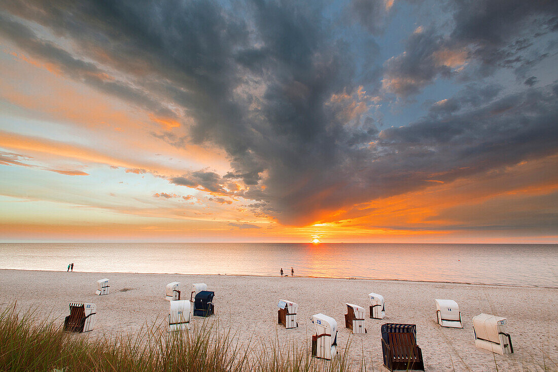 Sunset at a Baltic sea beach with dune grass and beach chairs, Dierhagen, Mecklenburg Vorpommern, Germany