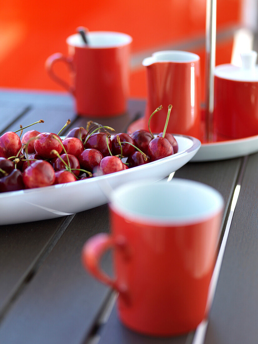 Red cherries on a porcelain plate, red cups, Mallorca, Spain