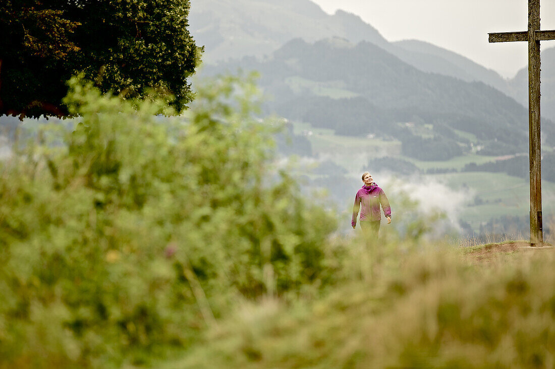 Woman hiking in the mountains, Chiemgau, Bavaria, Germany