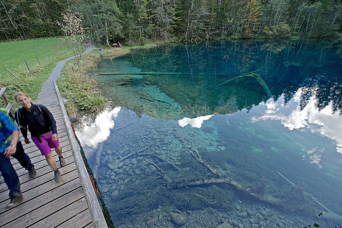 A man and a woman hiking at a small lake, Oberstdorf, Bavaria, Germany