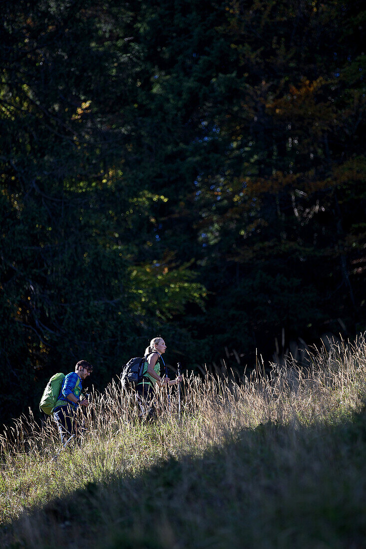 A man and a woman hiking in the mountains, Oberstdorf, Bavaria, Germany