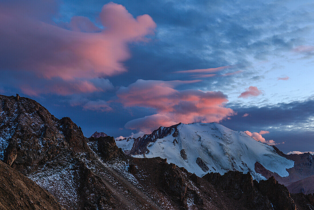 Illuminated lenticularis clouds over Tujuksu glacier, Peak Lokomotiv, Sailiski Alatau, National Park Ile Alatau, Almaty region, Kazakhstan, Central Asia, Asia