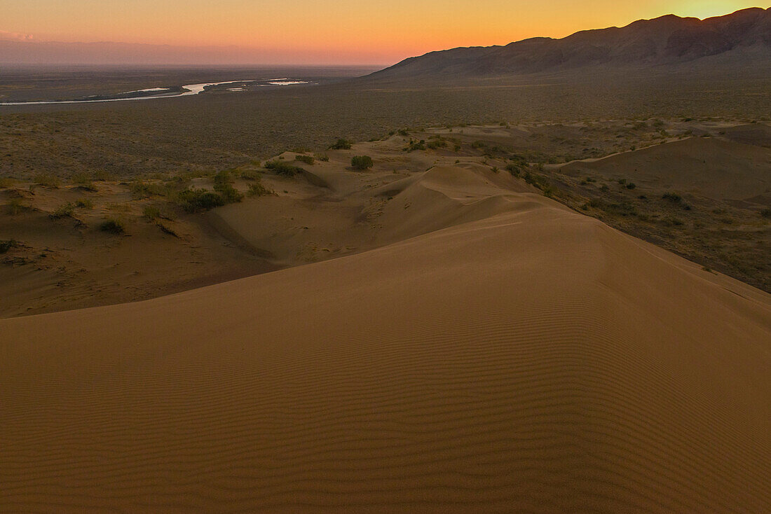 View from singing dune to Ili river valley and mountain ranges of Dzungarian Alatau, desert at Altyn Emel National Park, Almaty Region, Kazakhstan, Central Asia, Asia