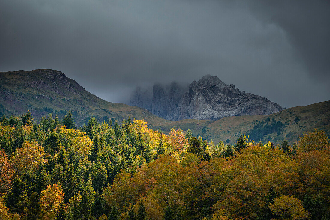 Stormy mood and autumn colors at mountain Castillo de Achert, Valle de Hecho, Parque Valles Occidentales, Pyrenees, Province Huesca, Aragon, Spain