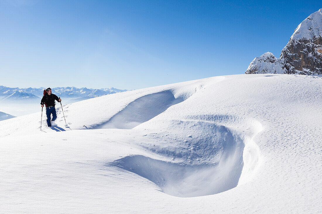 Snowshoe hiker, overlooking Riffl, Tennengebirge mountains, Salzburg, Austria