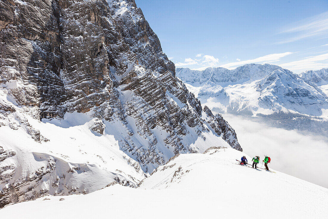 Backcountry skiers preparing to rappel, Neue-Welt-descent, Zugspitze, Ehrwald, Tirol, Austria