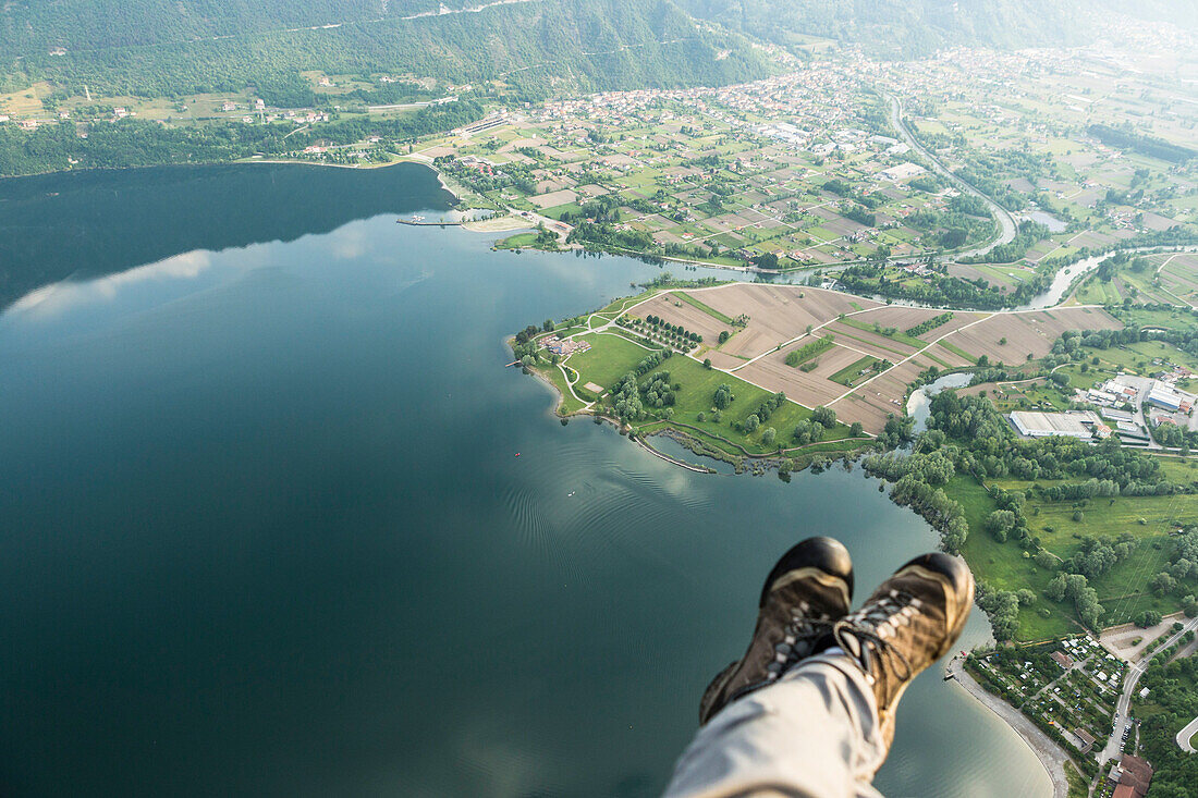 Paraglider's feet above Idro lake, Ponte Caffaro, Lombardia, Trentino, Italy