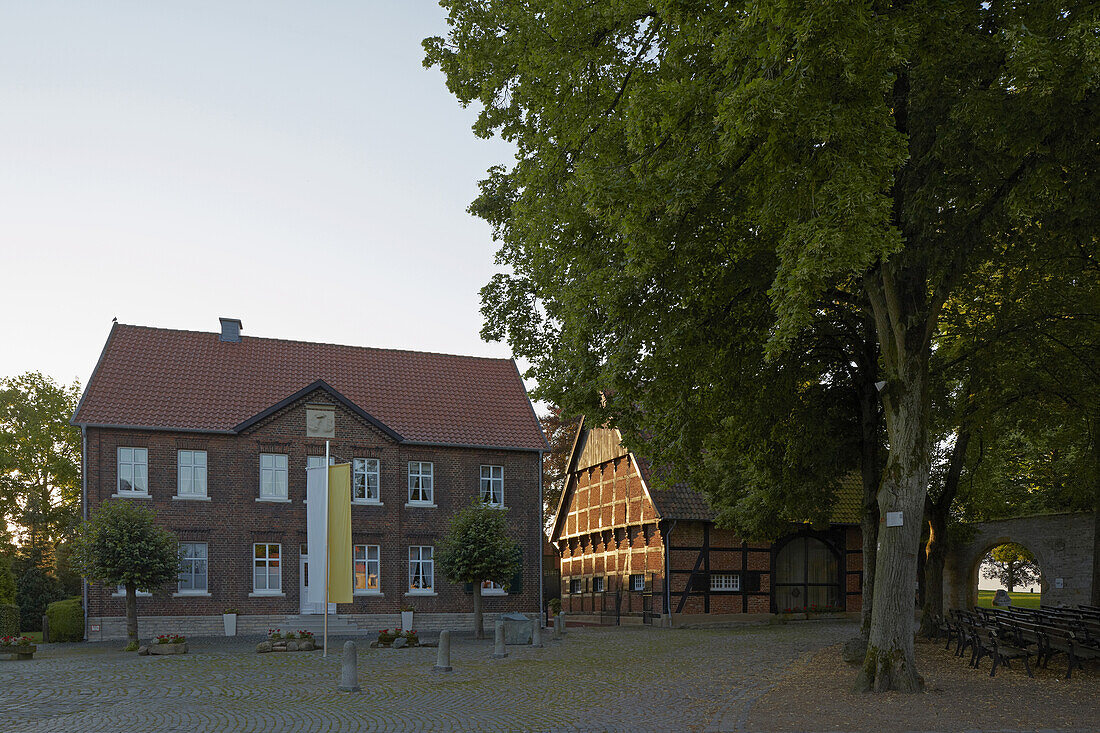 Timber-framed house and brick-house  and part of wall with gate at the  Burgplatz at Stromberg - town of Oelde , Muensterland , North Rhine-Westphalia , Germany , Europe