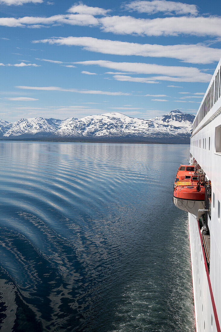 Side of cruise ship MS Deutschland (Reederei Peter Deilmann) and snow-covered mountains, Tromsø, Troms, Norway