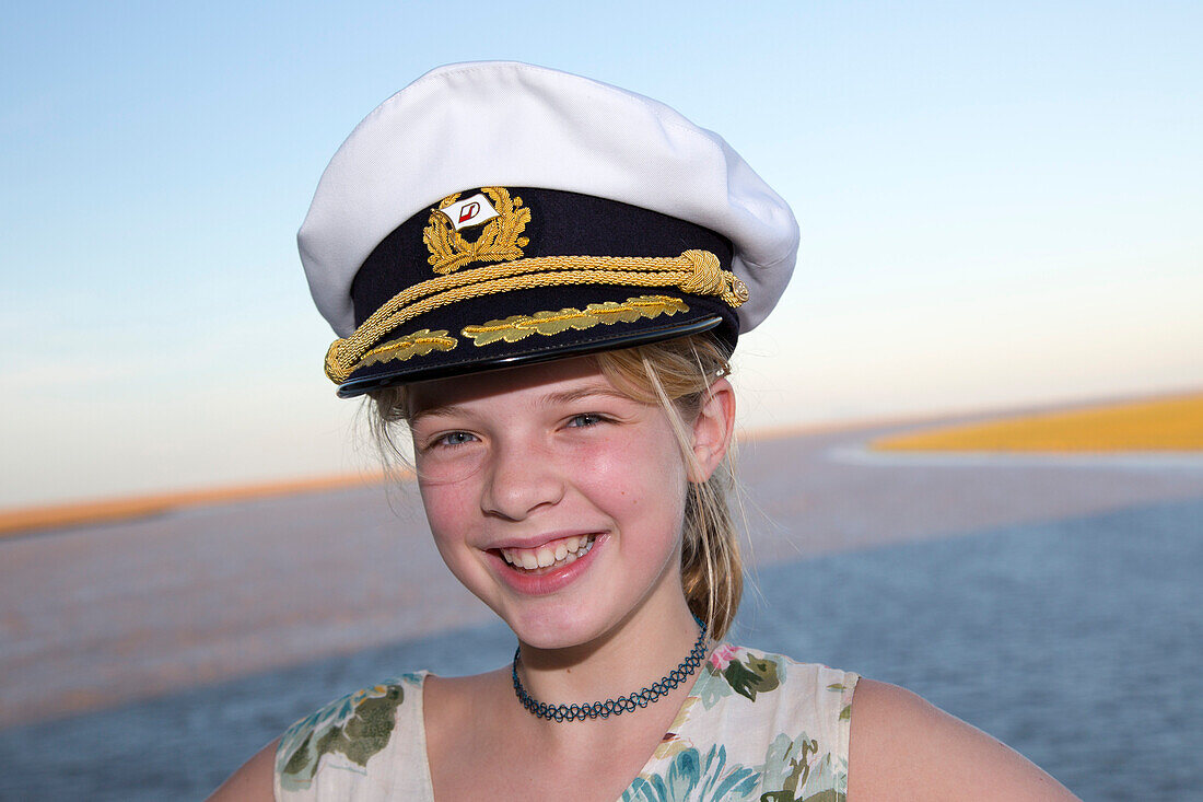 Young girl with captain's hat aboard cruise ship MS Deutschland (Reederei Peter Deilmann) [MR], near Seville, Andalusia, Spain