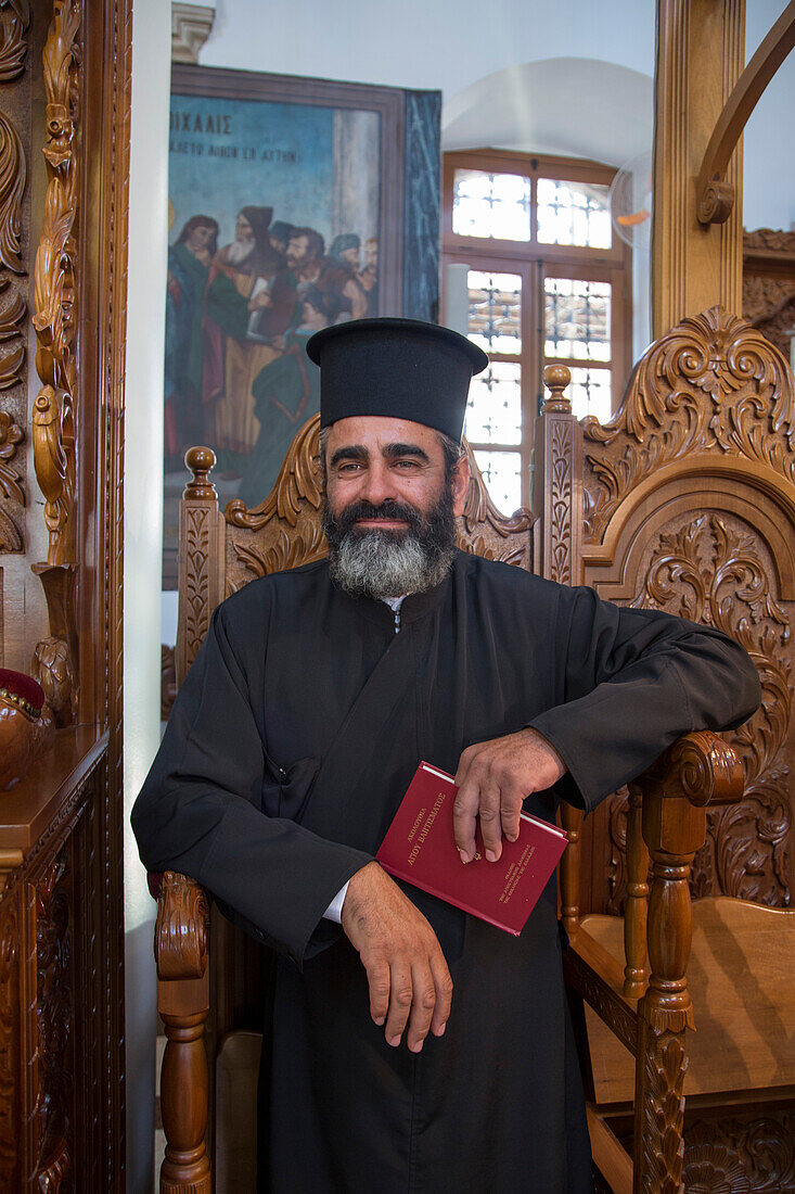 Minister during baptism service inside the Church of the Holy Cross, Omodos, Limassol, Cyprus