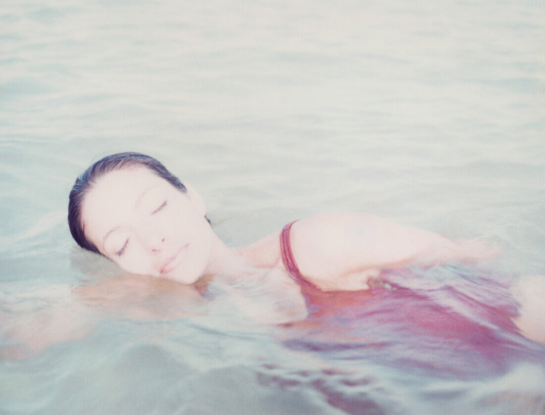 Woman swimming in calm water