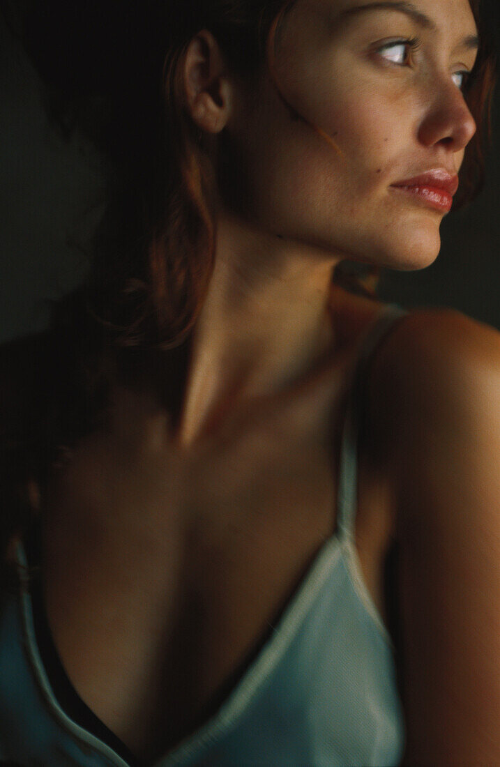 Woman wearing camisole, looking over shoulder, portrait